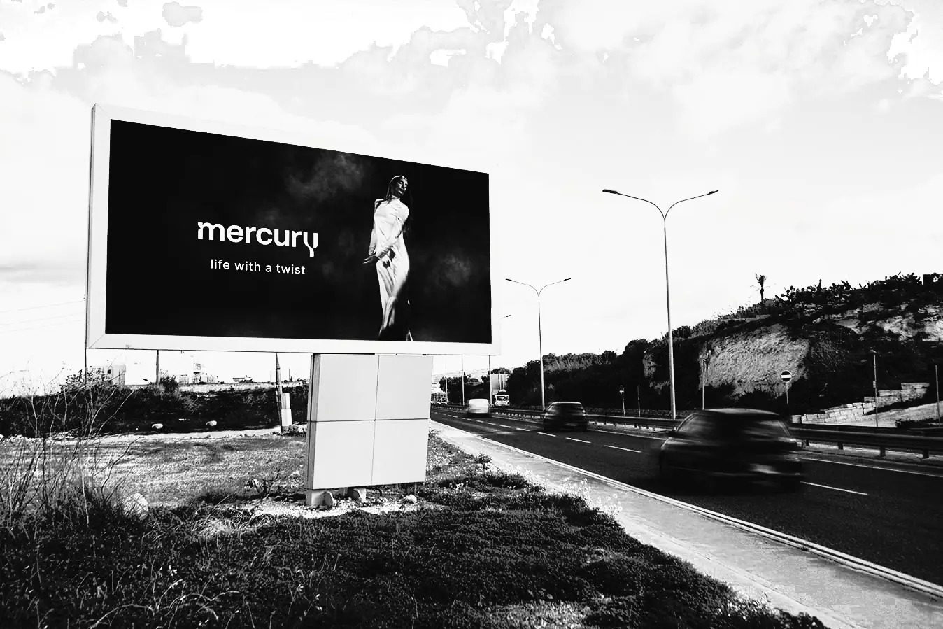 FACES roadside billboard with Mercury campaign, coast road and passing traffic